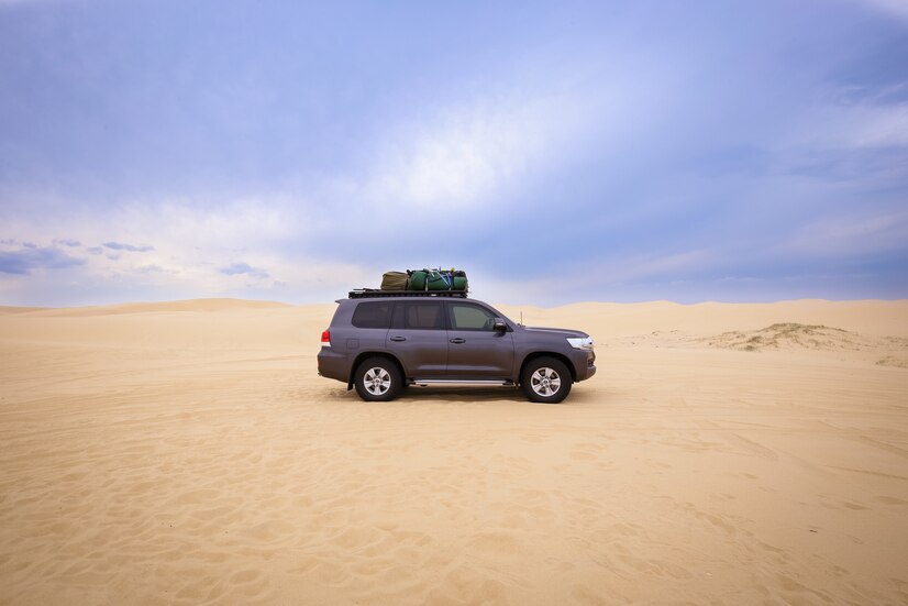 car-with-baggage-top-it-desert-cloudy-sky-daytime_181624-9723